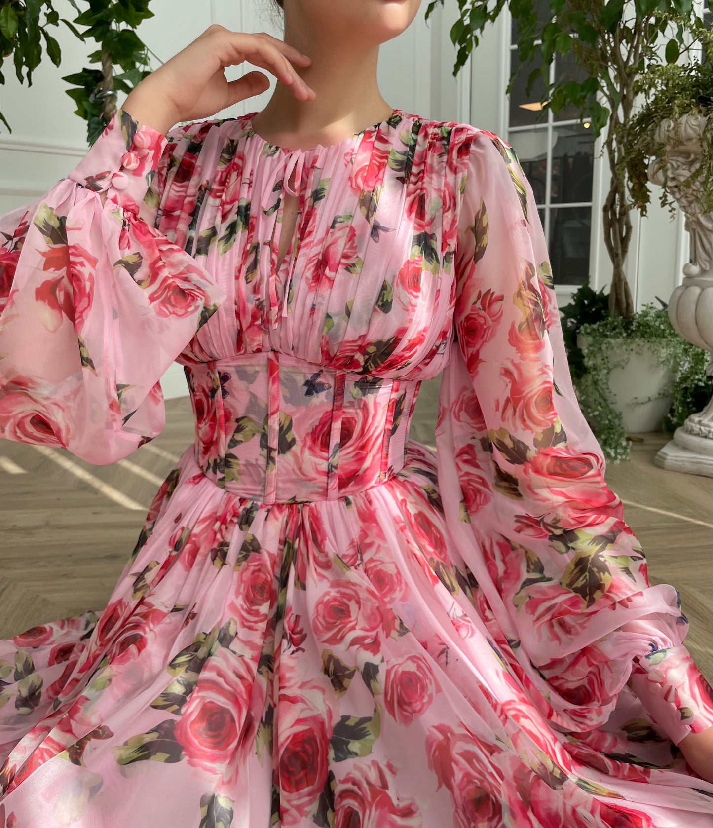 Pink mini dress with long sleeves and printed flowers