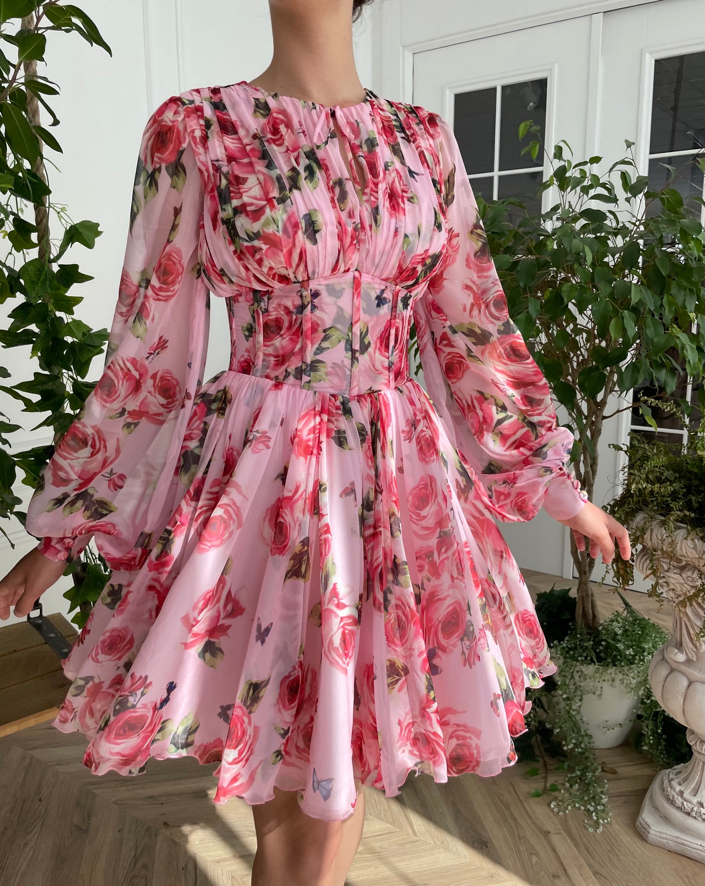 Pink mini dress with long sleeves and printed flowers