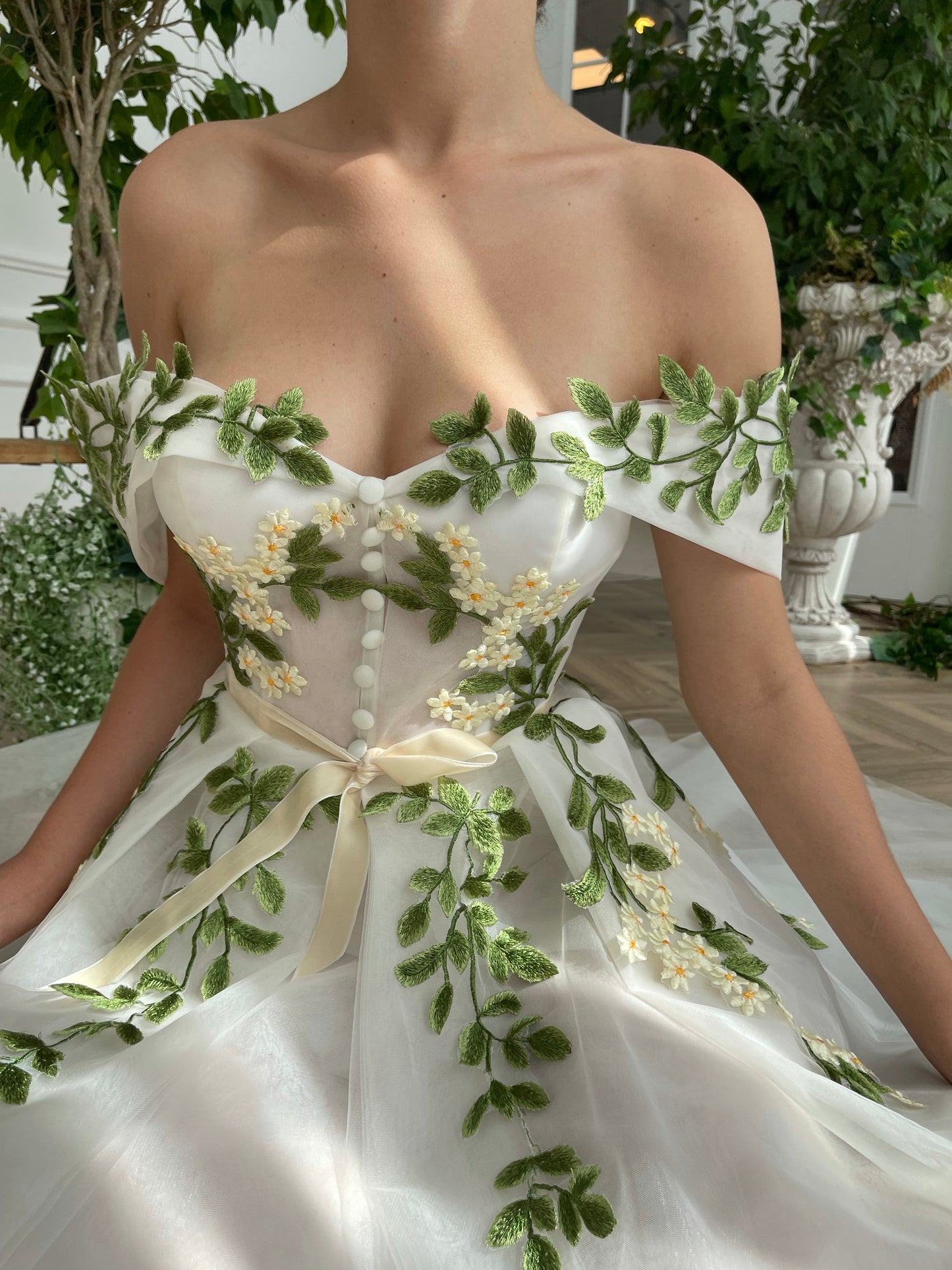 Midi white bridal dress with off the shoulder sleeves and embroidered vines and flowers