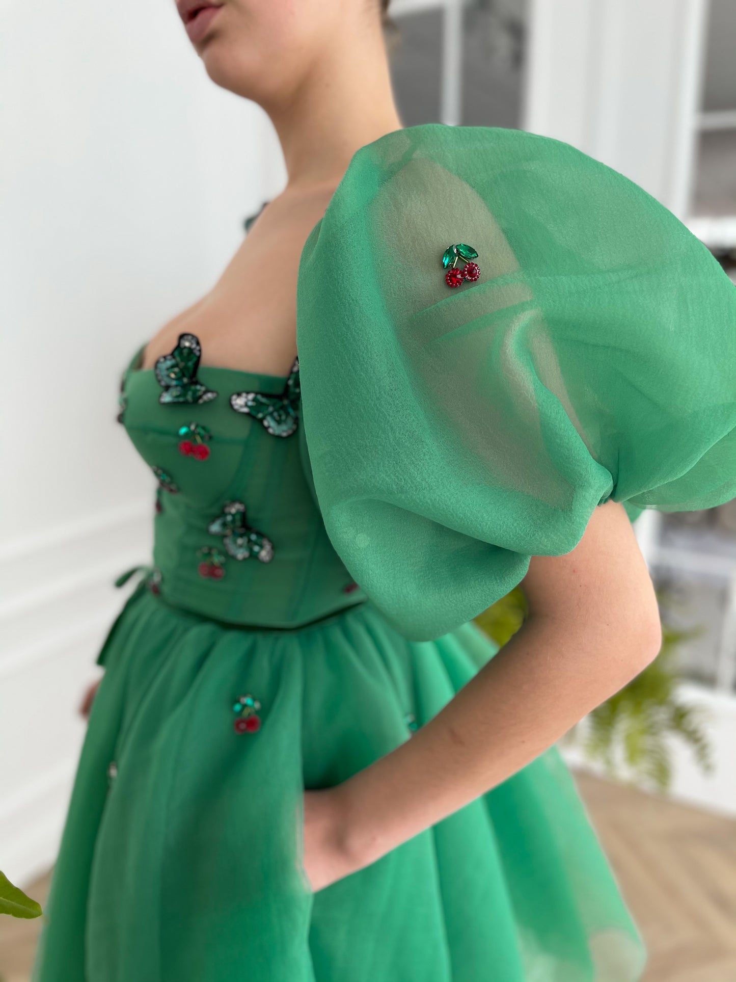 Green mini dress with embroidered cherries, butterflies and off the shoulder sleeves 