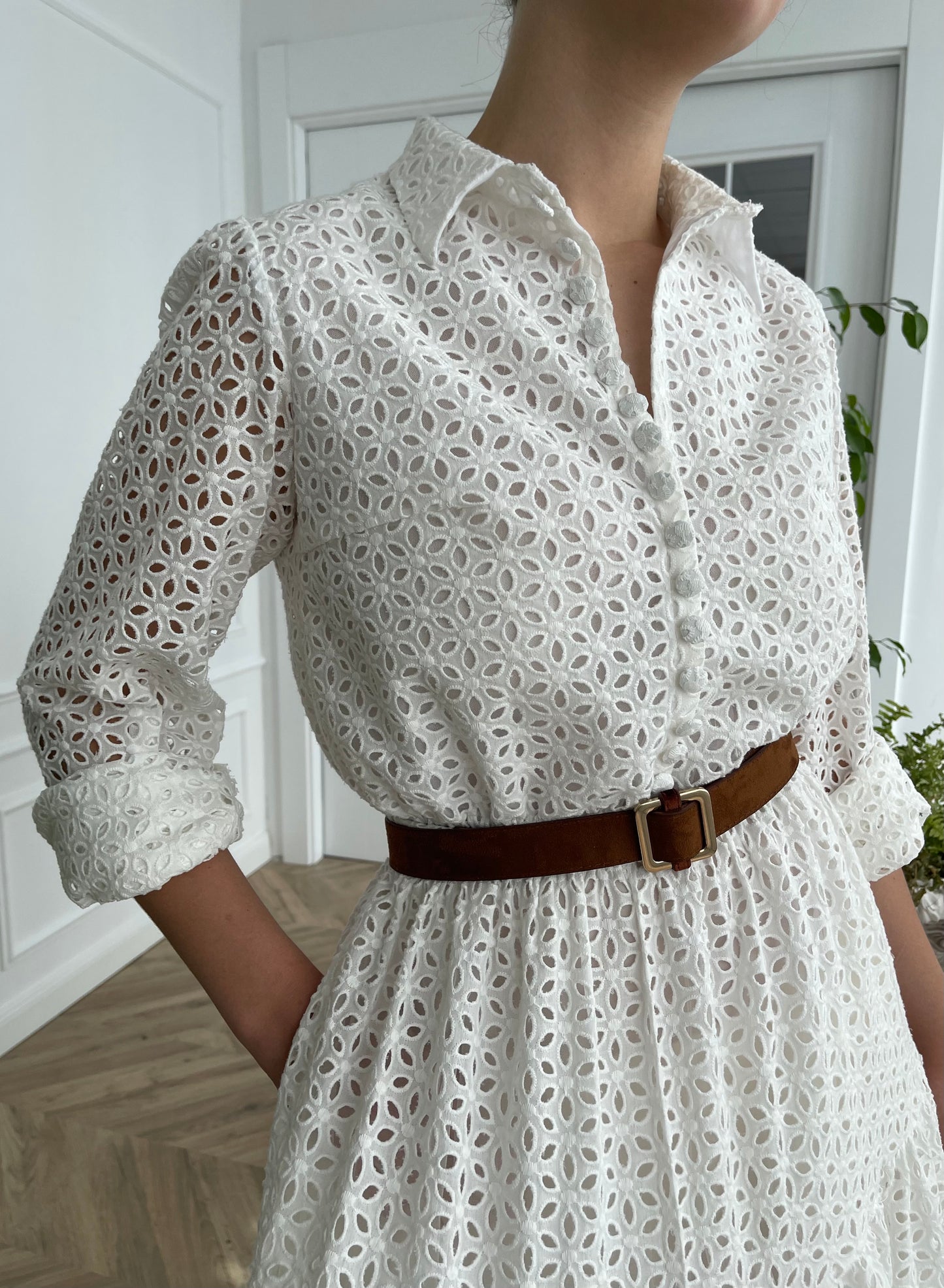 A line white bridal dress with brown belt and long sleeves