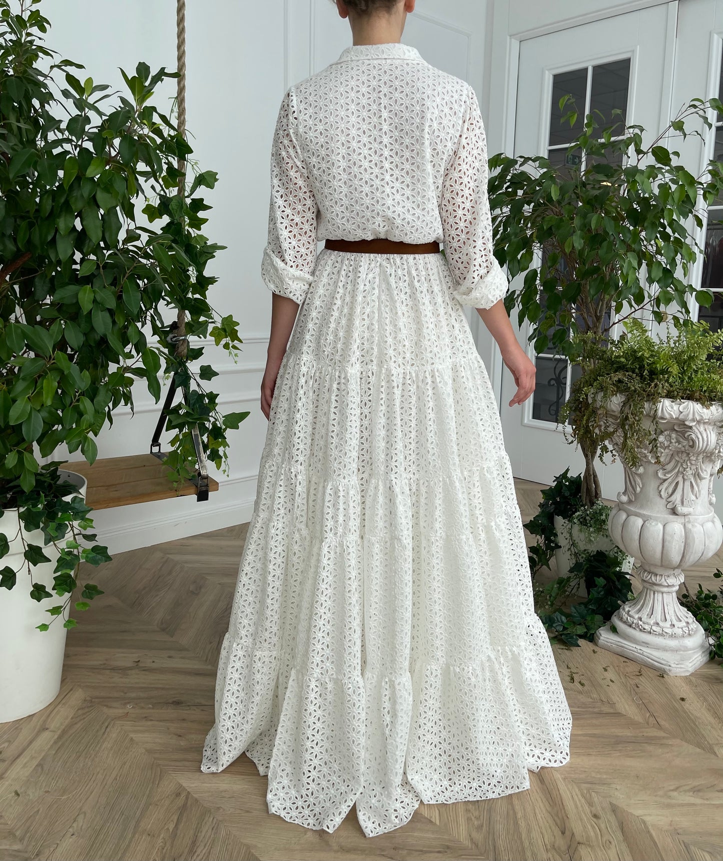 A line white bridal dress with brown belt and long sleeves