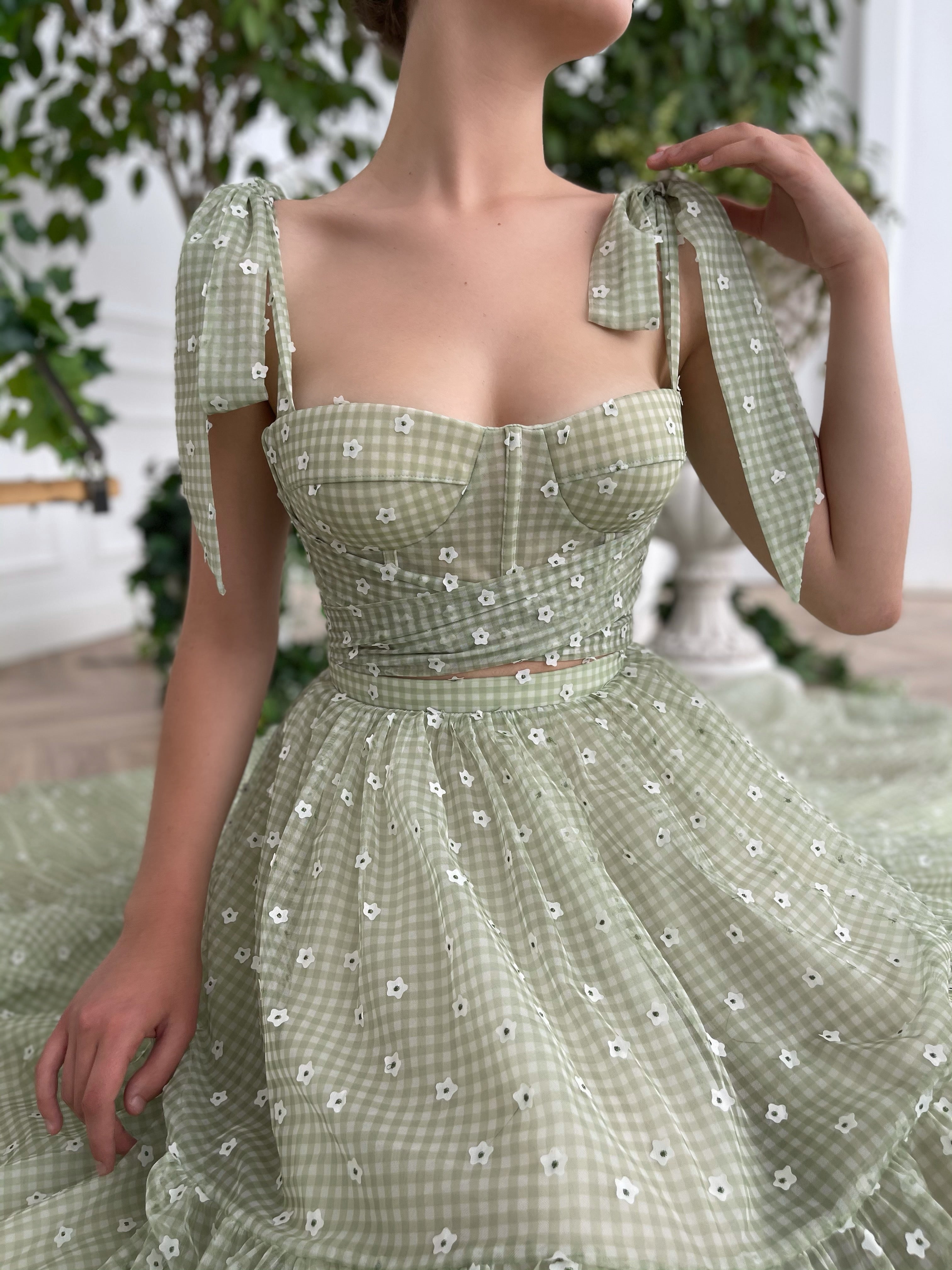 Green two piece dress with bow straps and daisies