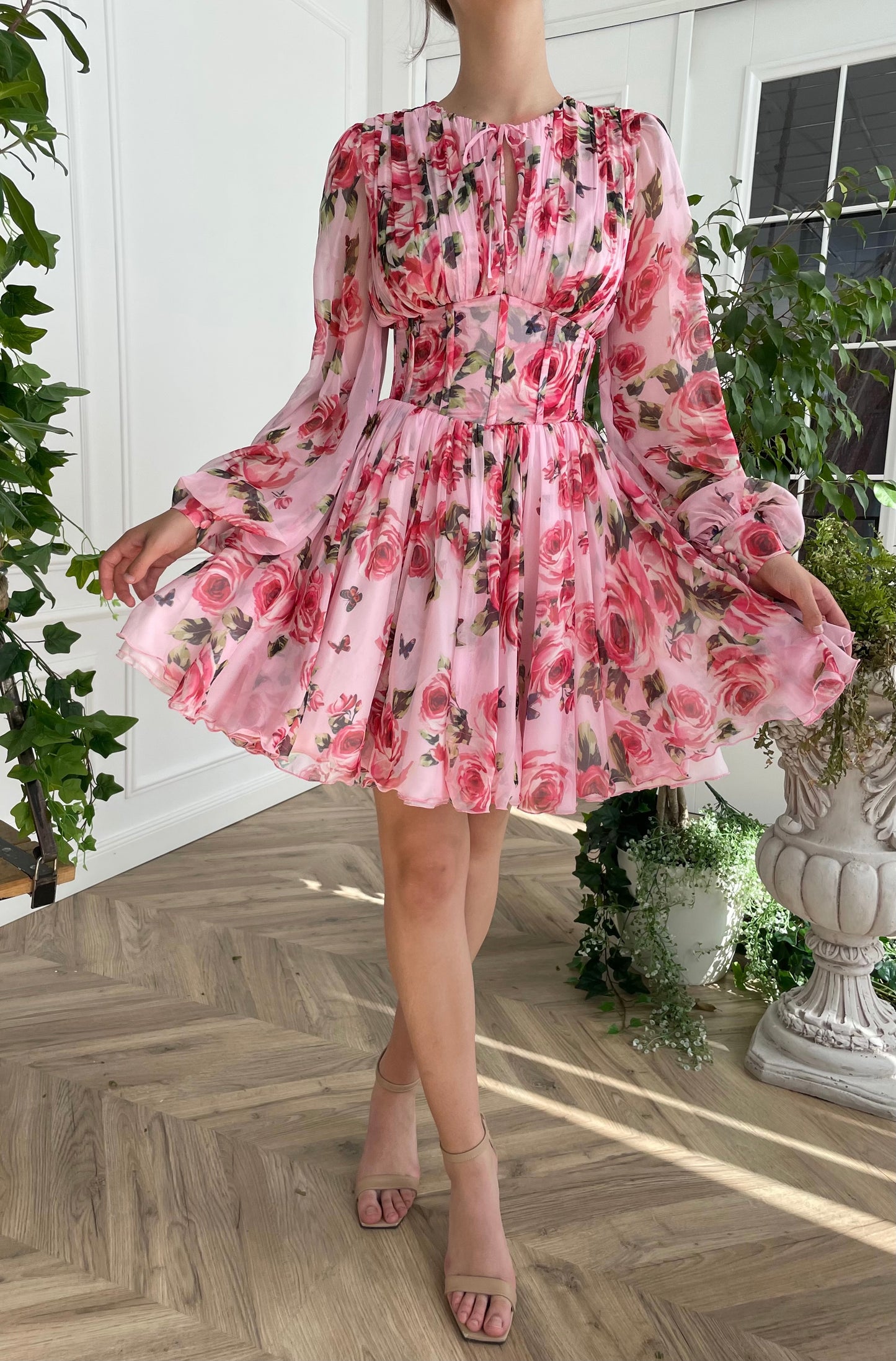 Pink mini dress with long sleeves and printed flowers