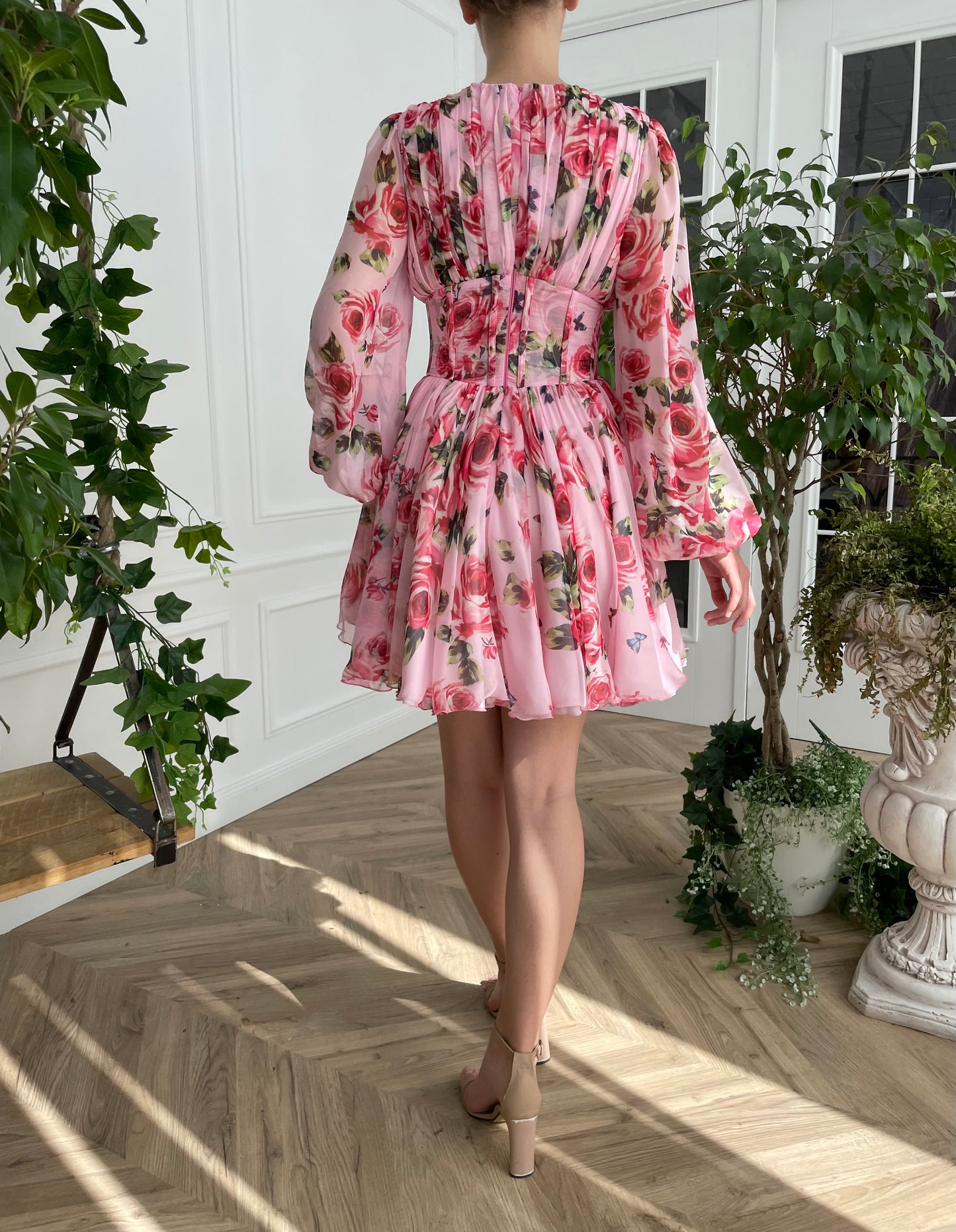 Pink mini dress with long sleeves and printed flowers