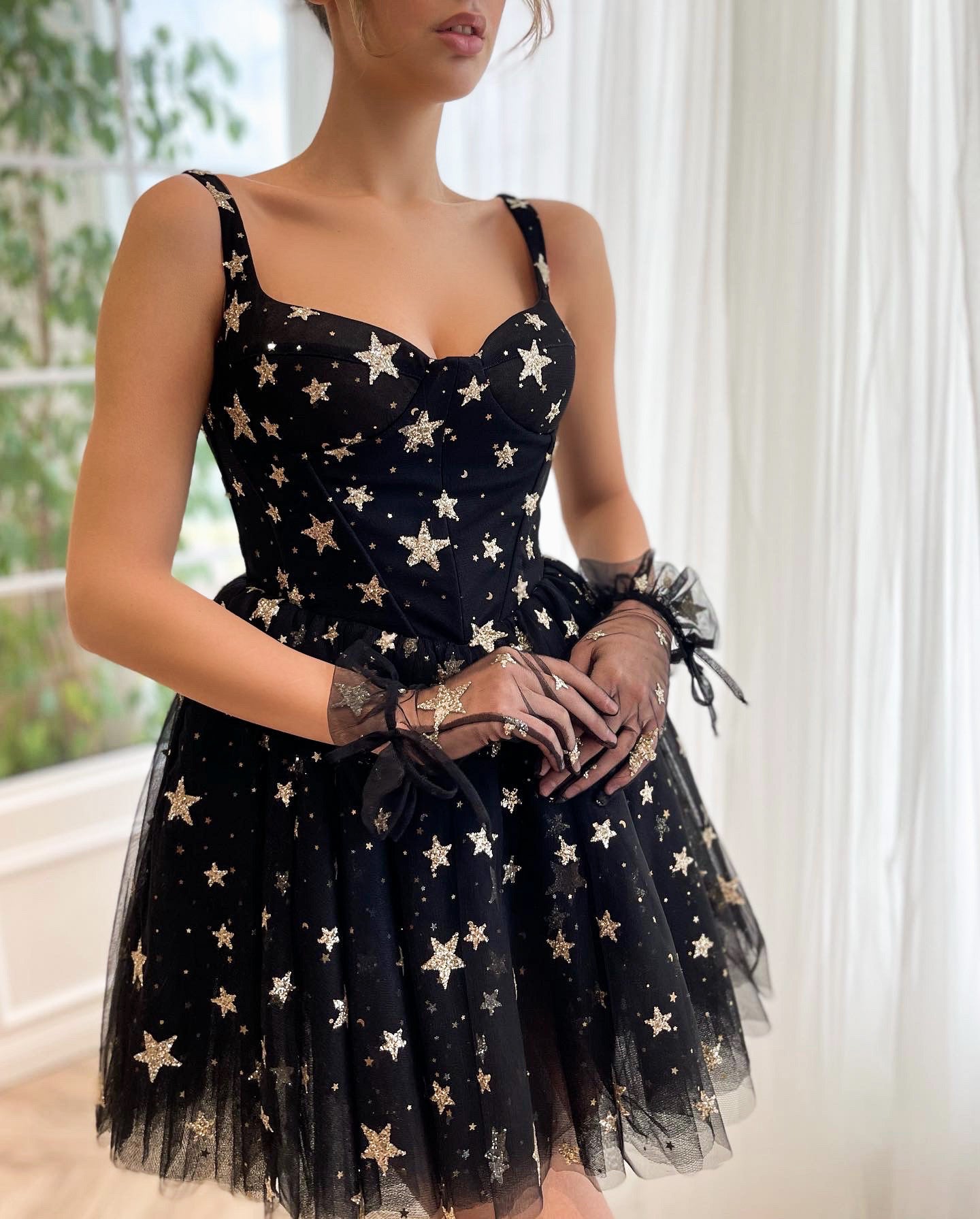 Black mini dress with straps, gloves and starry fabric