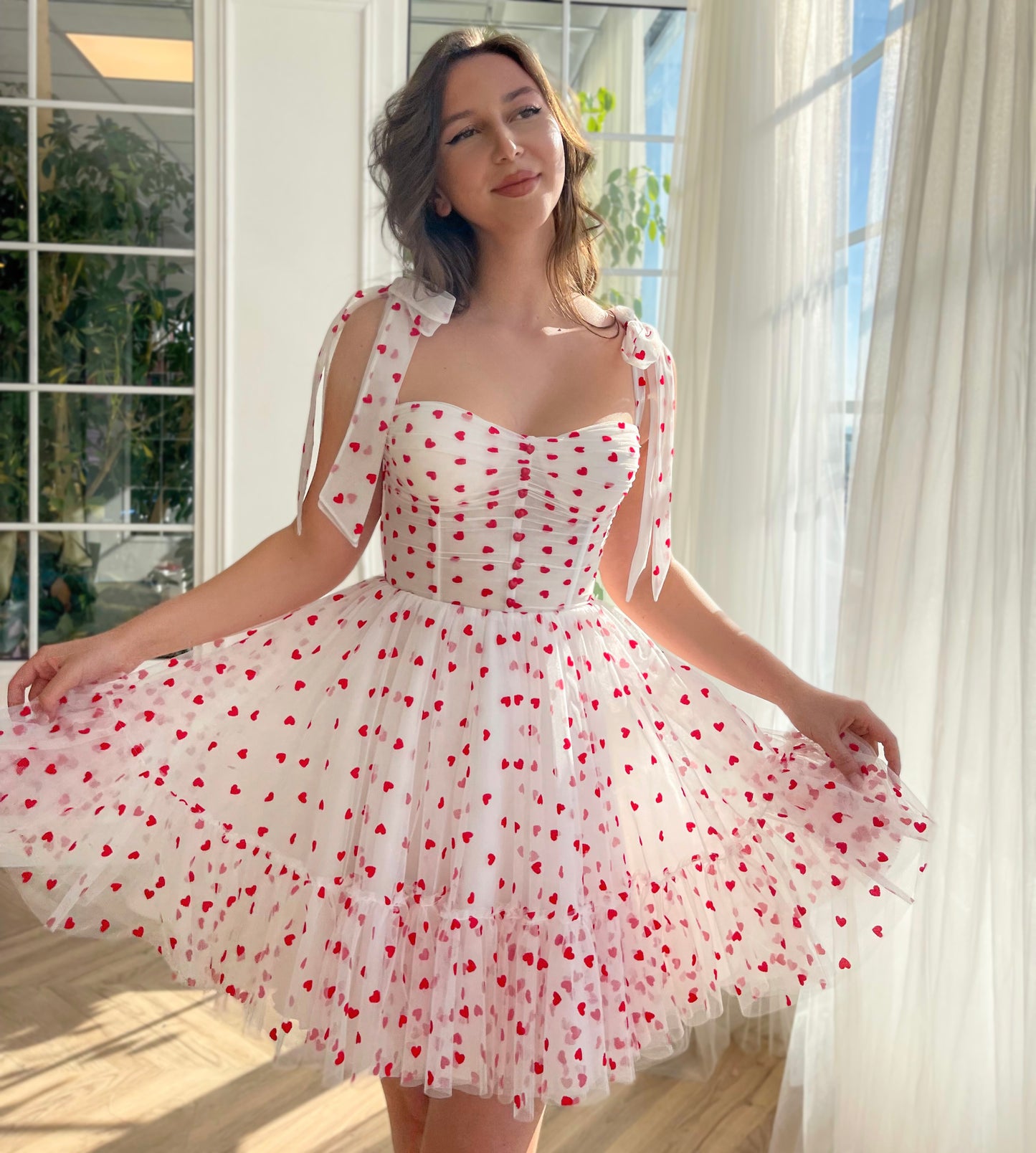 White mini dress with hearty print and bow straps