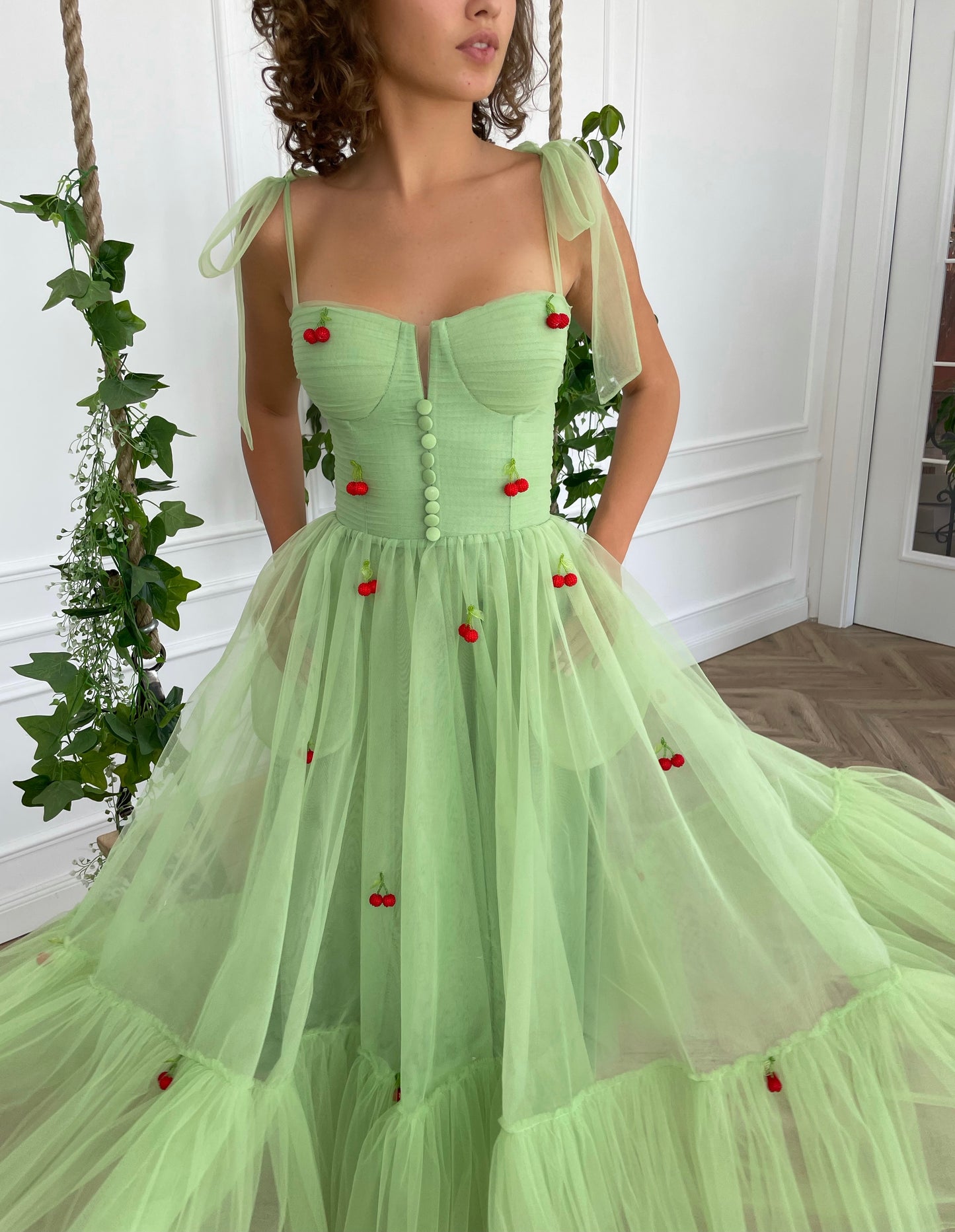 Green midi dress with bow straps and embroidered cherries