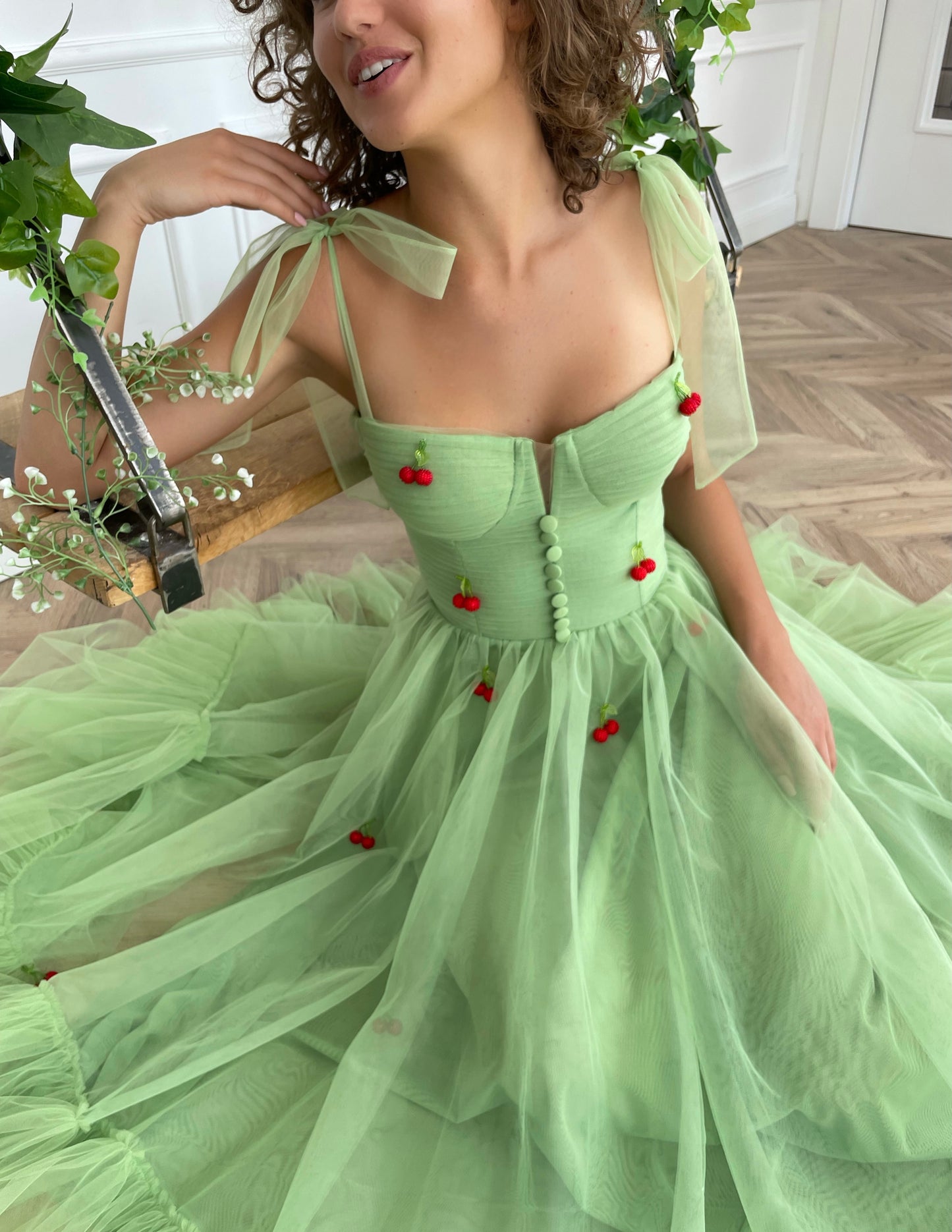 Green midi dress with bow straps and embroidered cherries