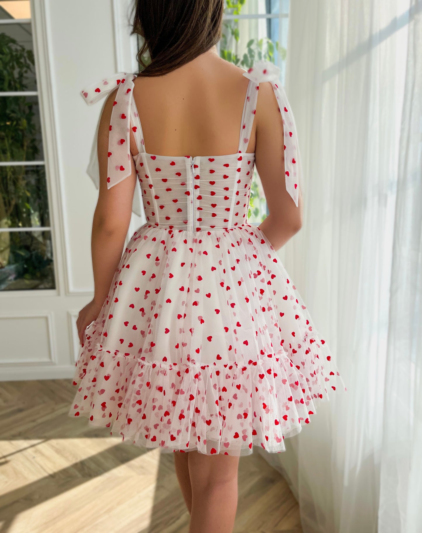 White mini dress with hearty print and bow straps