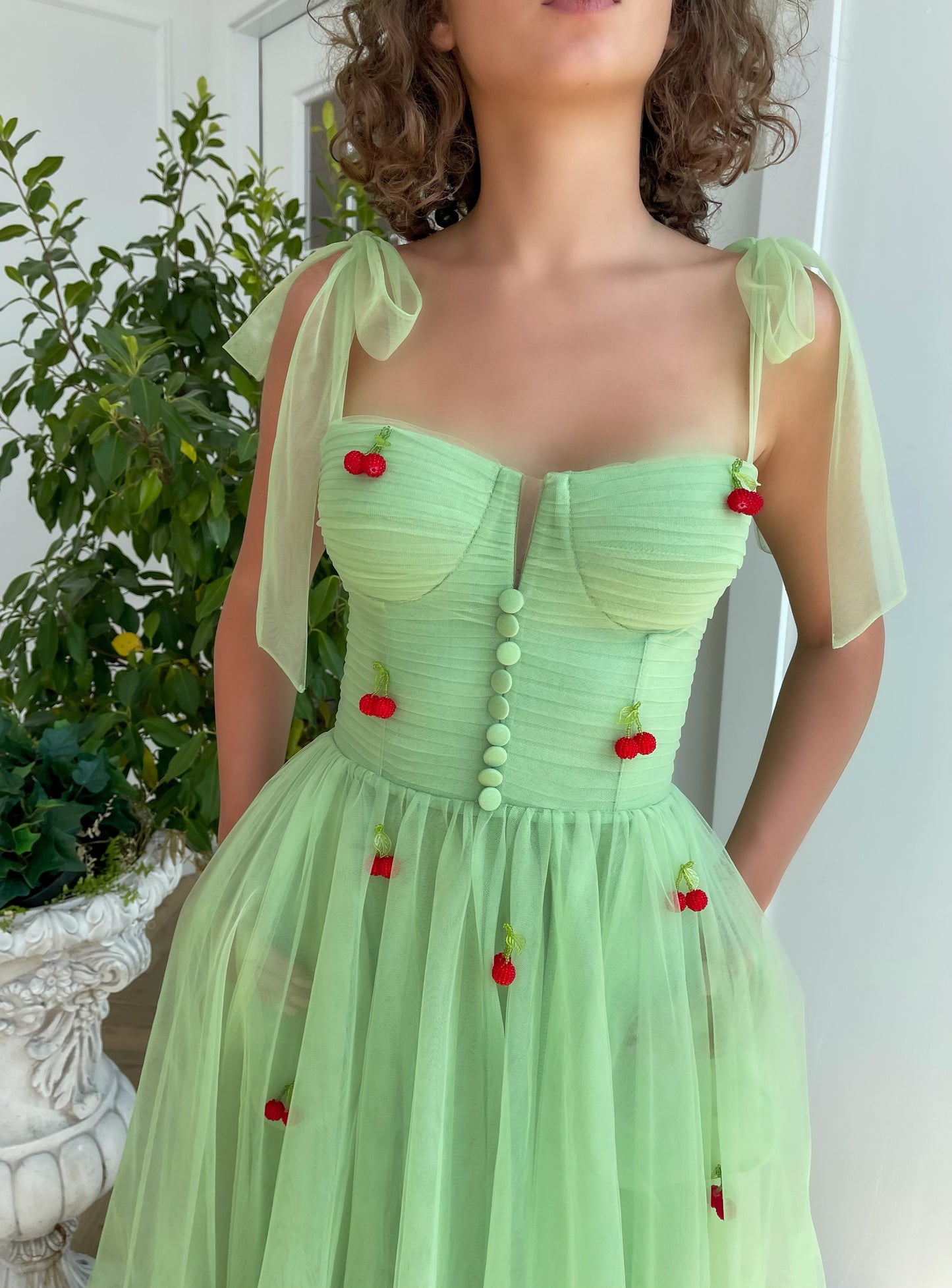 Green midi dress with bow straps and embroidered cherries