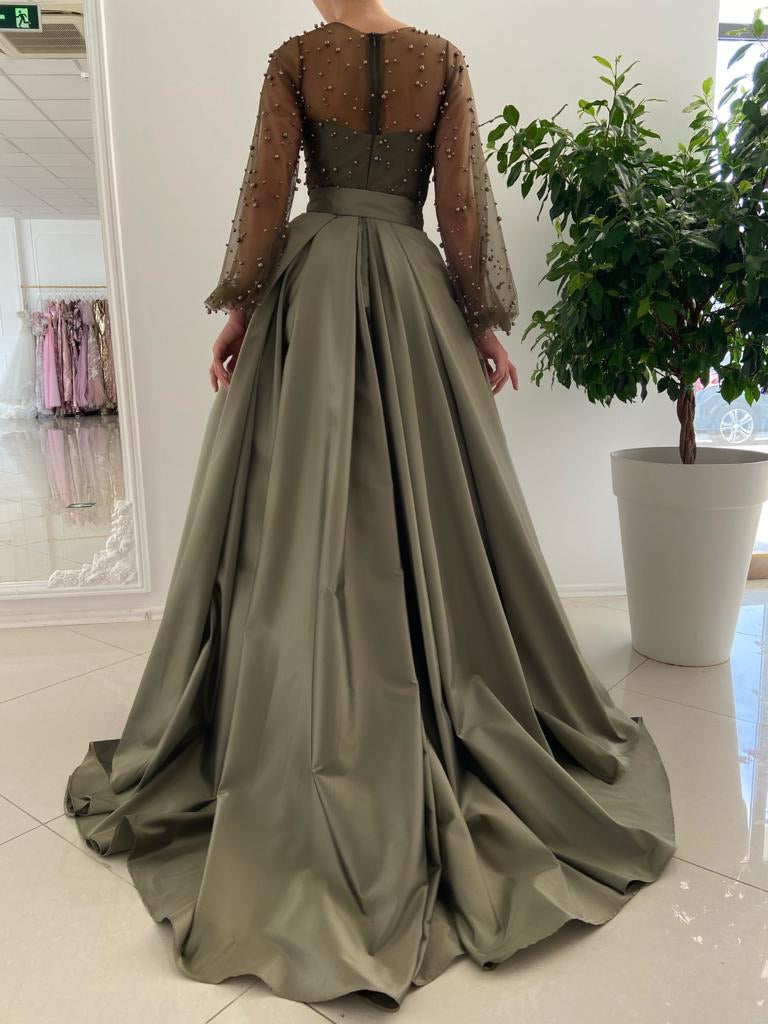 Green overskirt dress with long sleeves and beading