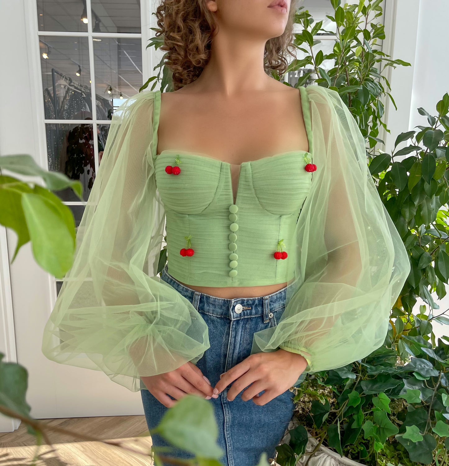 Green corset with long sleeves and embroidered cherries
