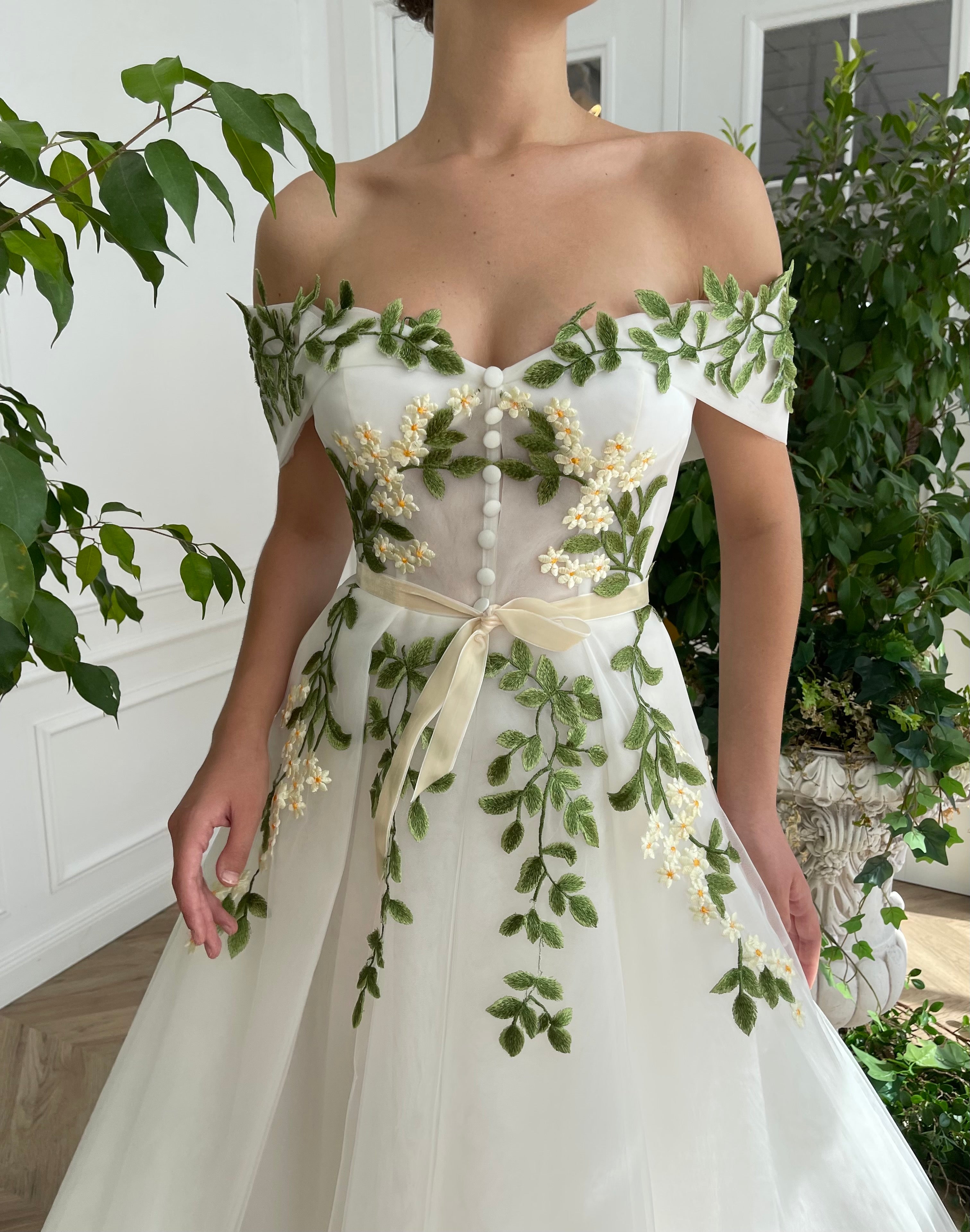 Midi white bridal dress with off the shoulder sleeves and embroidered vines and flowers