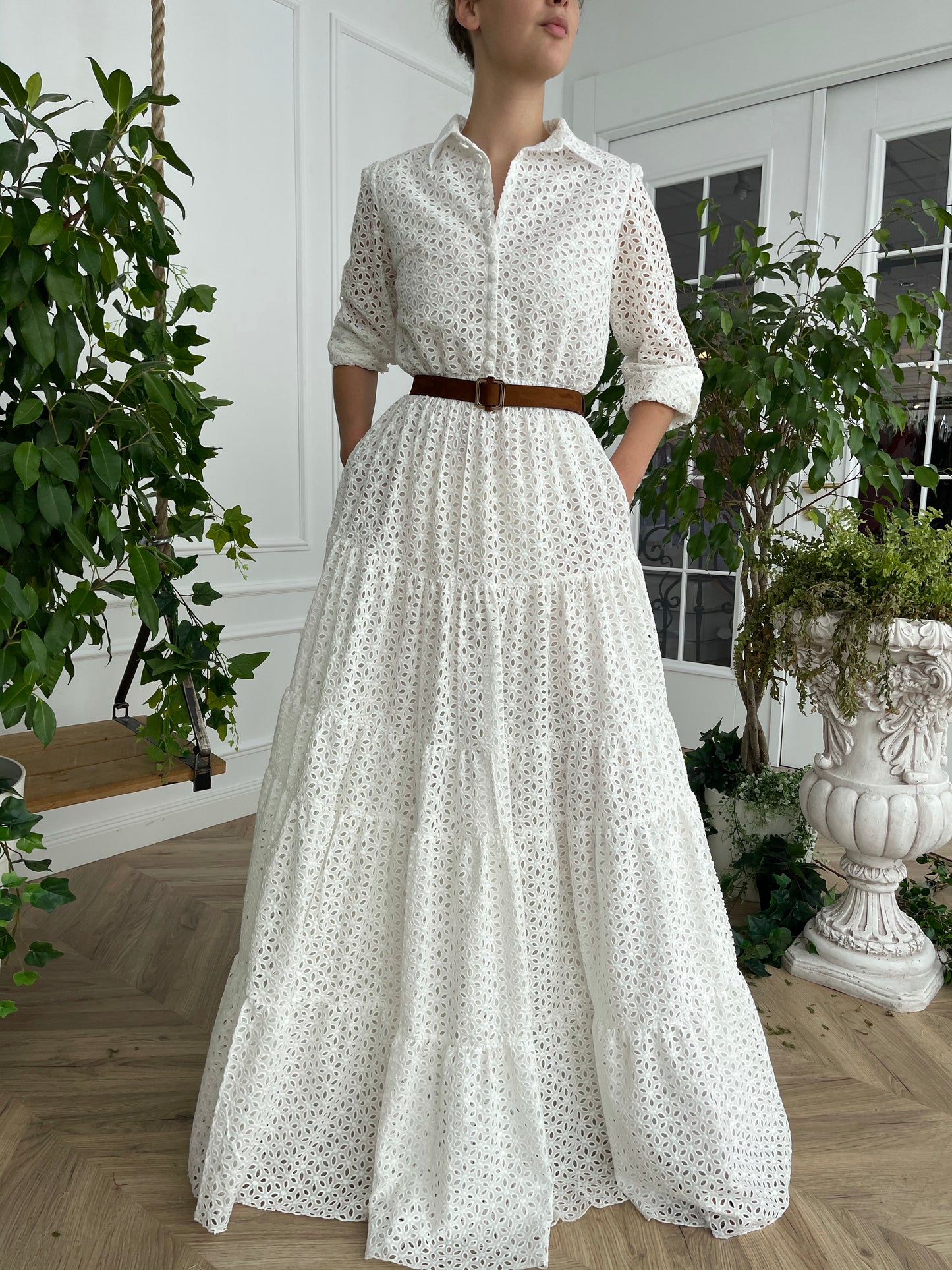 A line white bridal dress with brown belt and long sleeves