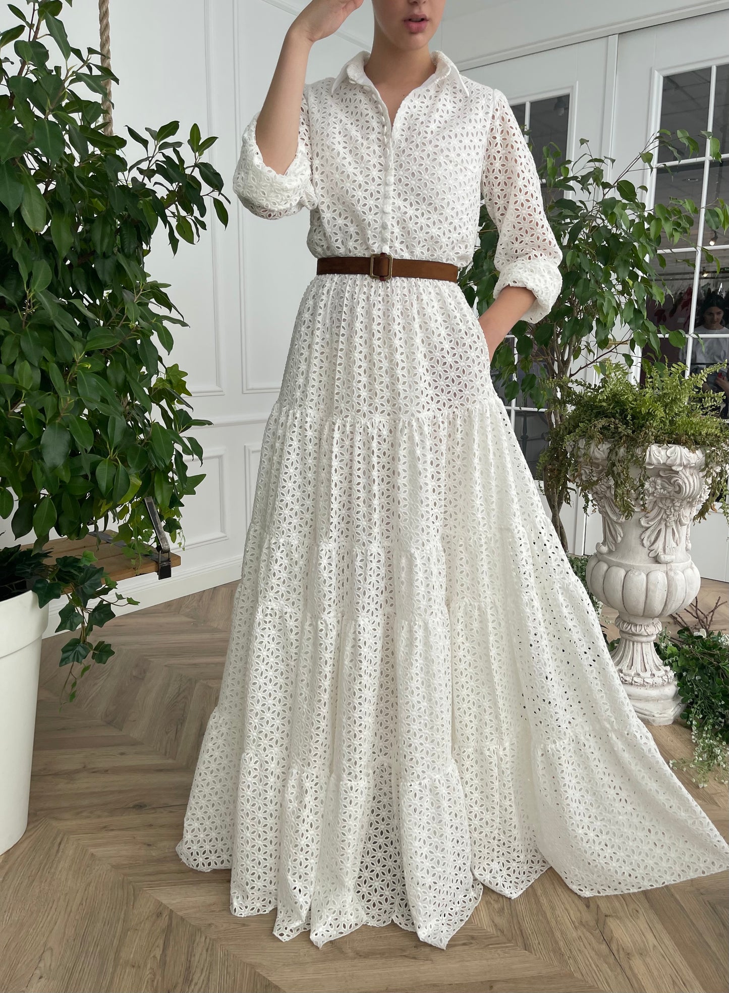 A line white bridal dress with brown belt and long sleeves