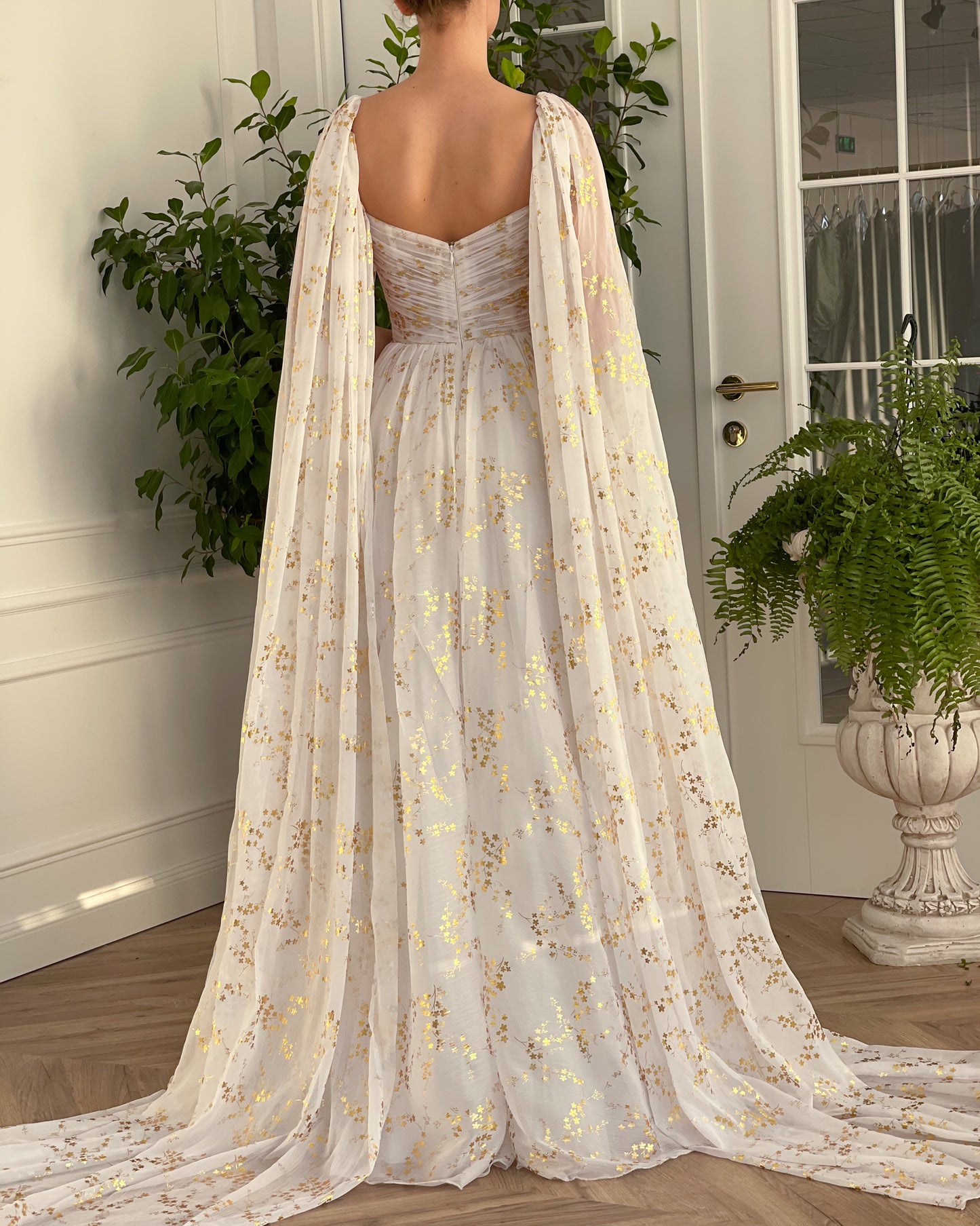 A line white bridal dress with cape, printed flowers and train