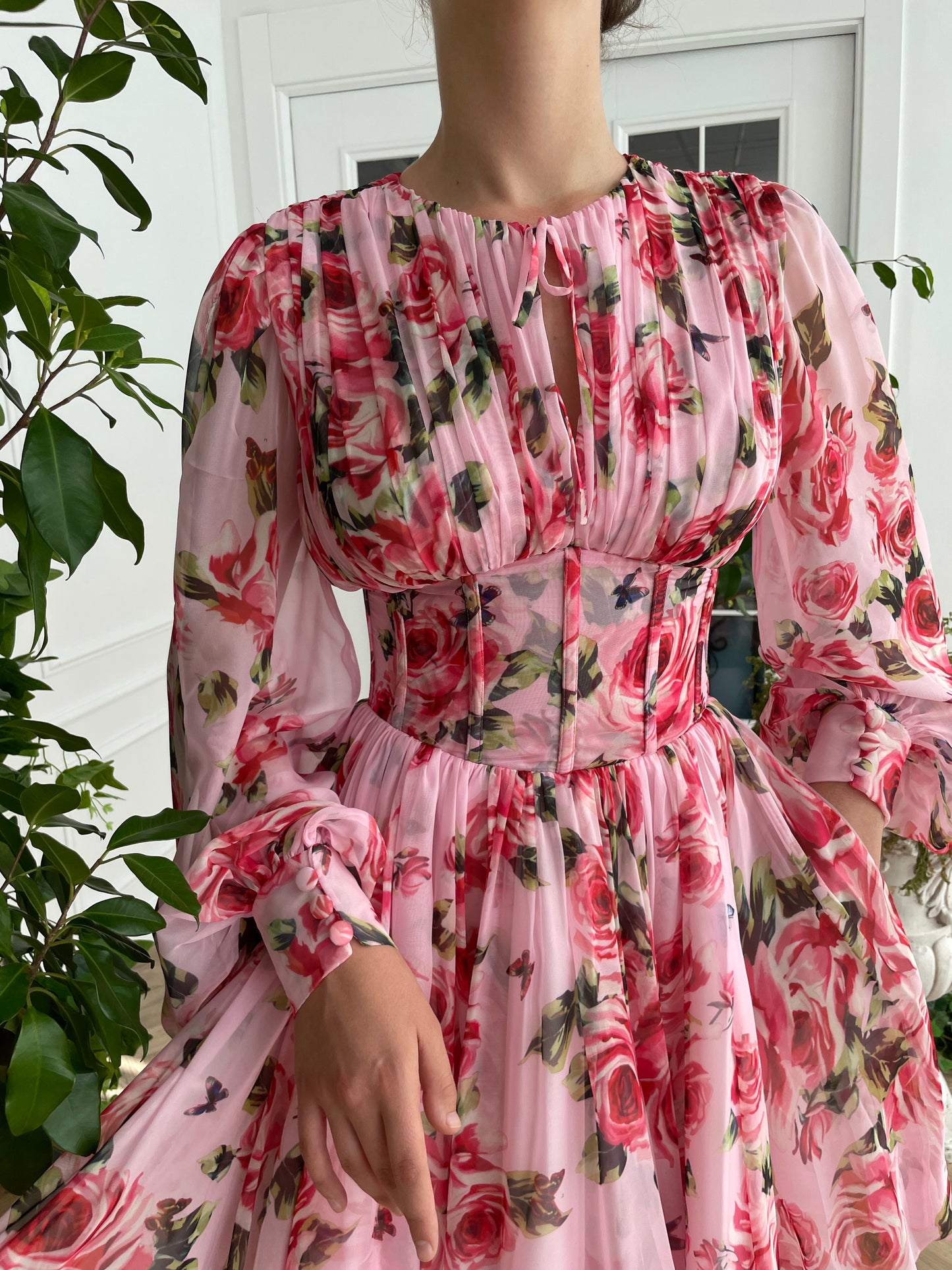 Pink mini dress with long sleeves and printed flowers
