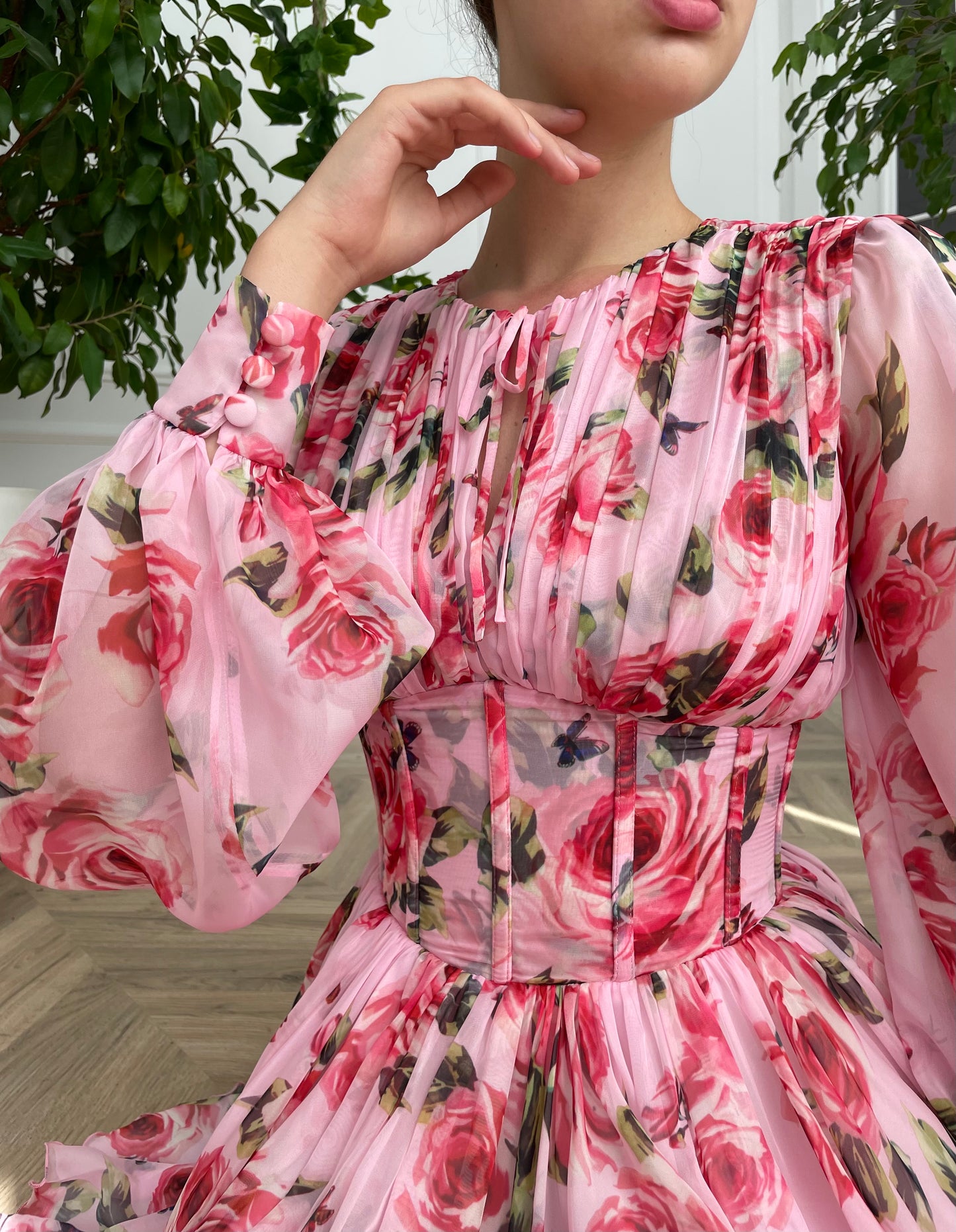 Pink mini dress with long sleeves and printed flowers