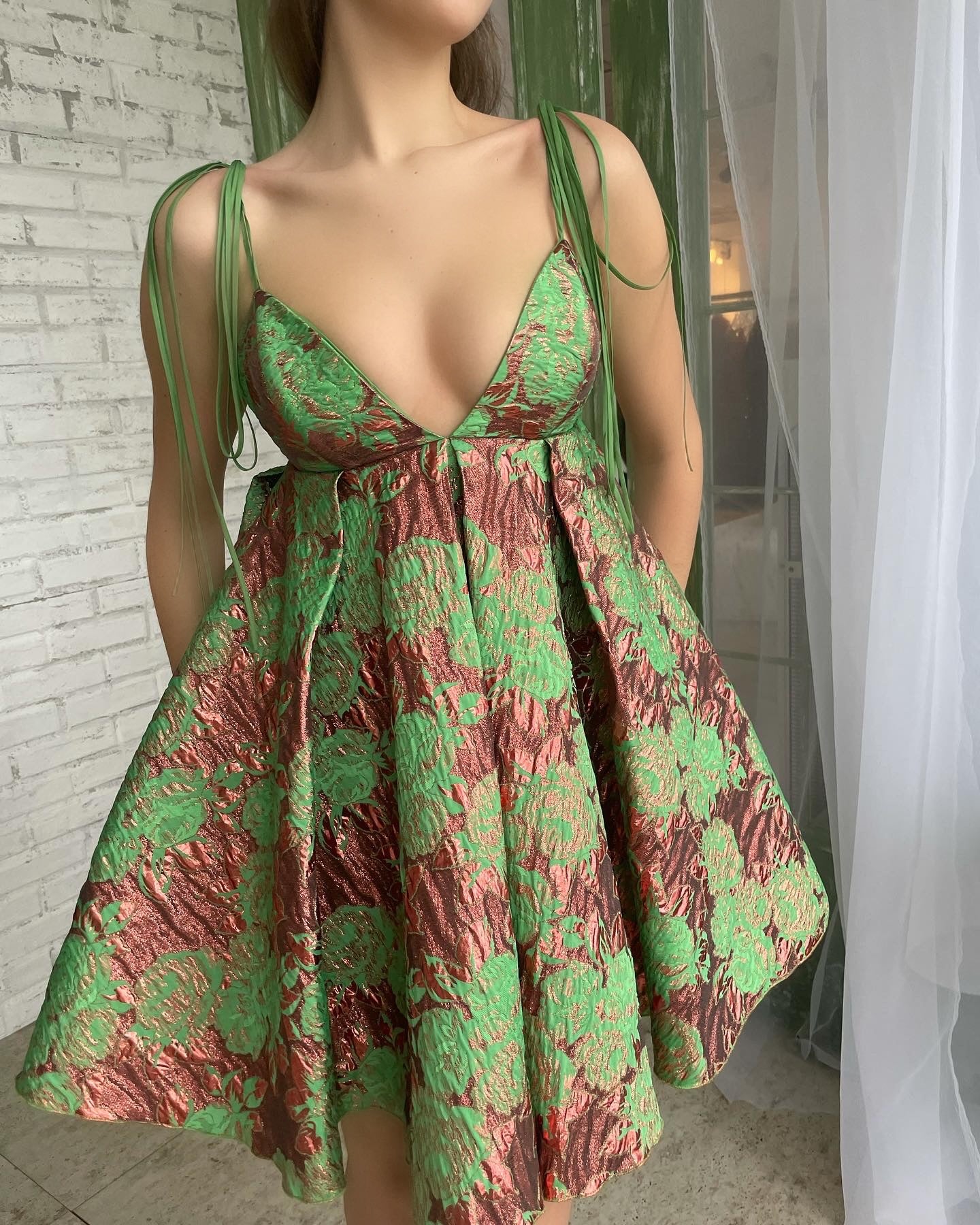 Green mini dress with spaghetti straps and v-neck