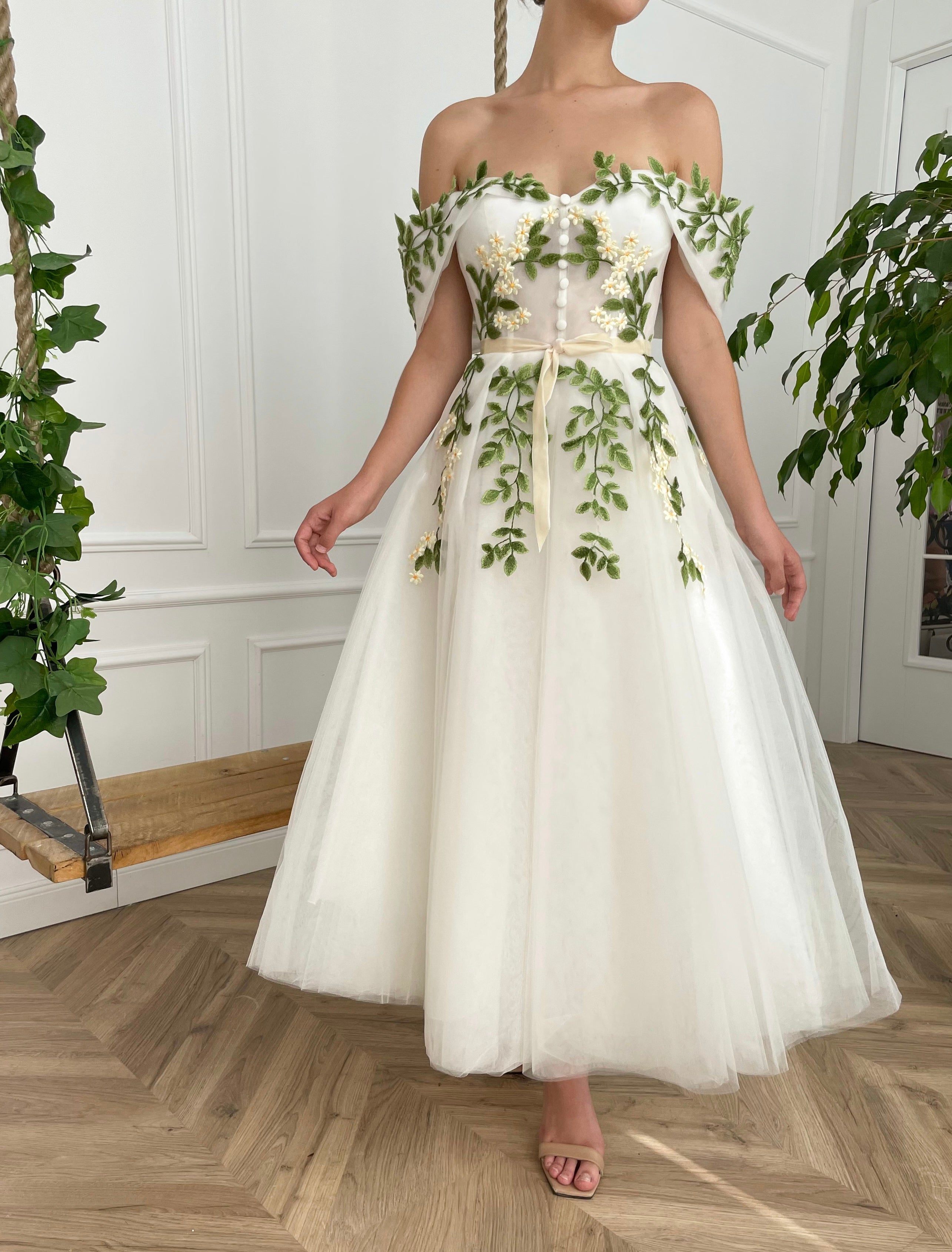 Midi white bridal dress with off the shoulder sleeves and embroidered vines and flowers